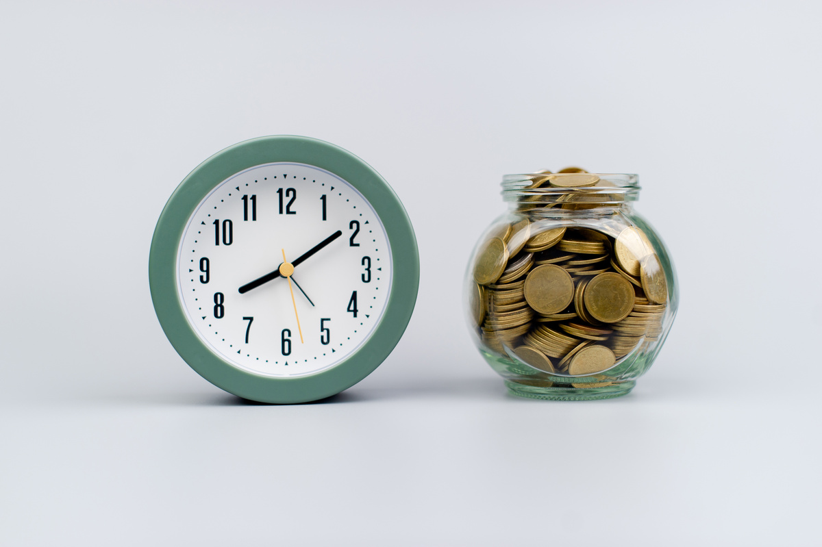 money and time saving money in a glass jar Saving money creates